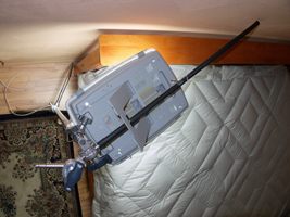 Photograph of Klarstein seasonal affective disorder lamp suspended from photograph light stand, showing how light stand arm can be rotated to move the lamp out of the user's way.
